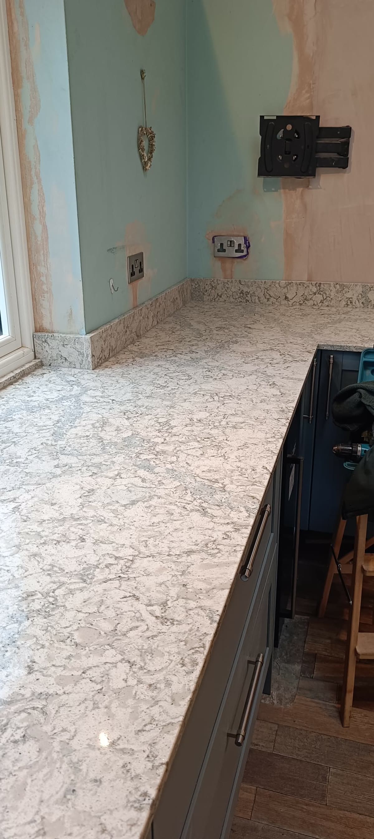 Szary blat kwarcowy z ciemnymi szafkami